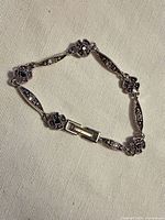 Full view of bracelet laid flat showing entire design and clasp