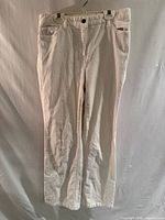 Front view of white corduroy pants on hanger