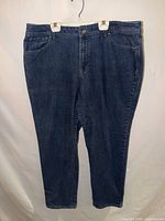 Full front view of jeans hung on hanger