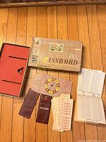 Full game layout showing box, insert, scoreboard, clue sleeves, word cards, score sheets
