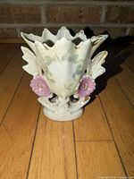 Front view showing floral ornaments, leaf pattern, overall form