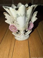 Front view showing applied pink roses, leaf motif, brand style