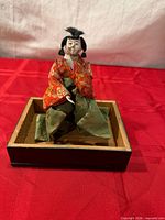 Front view of hina doll on wooden tray