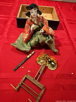 Front view of seated Hina doll with accessories displayed