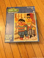 Front of boxed Sesame Street latch hook rug kit featuring Bert and Ernie artwork