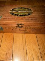 Top view of wooden Lacona cigar box showing label and clasp