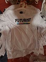 Stack of identical white FUTURIST long sleeve shirts on hangers