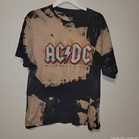 Full front view of acid-wash AC/DC tee on hanger