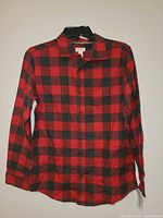 Front view of red and black plaid Cat & Jack shirt on hanger