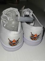 Rear view showing campfire graphic on both heel counters