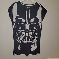 Full front view of black t-shirt with large white Darth Vader graphic