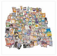 Full overhead view showing large quantity of sealed Happy Meal toys