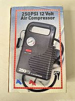 Box front showing 250 PSI 12 V air compressor image and accessories