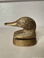 Side view of brass duck stapler