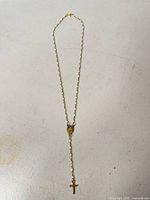 Full view of rosary showing overall length, bead spacing, centerpiece medal, and cross pendant