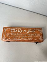 Top of orange case showing model and branding