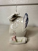 Front view showing dove, feather, rose and Lladró Society inscription