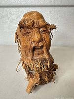 Front view of carved burl/root wood human head bust