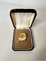 Watch head in open brown velvet box
