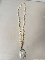 Full view of pearl opera necklace with pendant