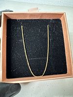 Necklace laid out in box showing overall length and chain style
