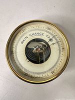 Full view of brass aneroid barometer front