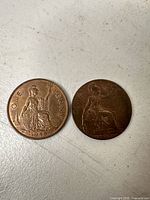 Both one penny coins front reverse sides visible