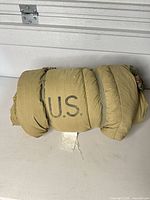 Rolled sleeping bag with U.S. stencil visible