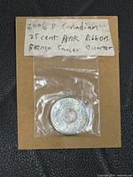 Front view of coin in sleeve with handwritten label