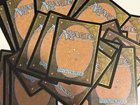 Stack of card backs showing Magic: The Gathering Deckmaster design