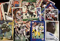 Spread of approximately 30 vintage football cards showing key examples: Pro Set Reggie White, Michael Irvin, Tracy Ham, Action Packed Reggie White and others