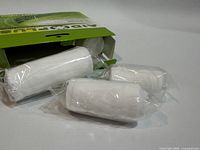 Box with three visible wrapped bandage rolls