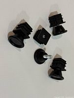 four adjustable leveling feet with square inserts laid out