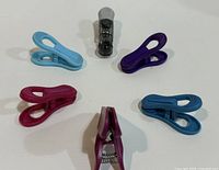 Six assorted plastic clips laid out