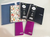 Group shot showing all seven spiral notebooks and memo pads