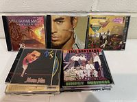 Front view showing several titled CDs including Steel Guitar Magic, Enrique Iglesias and Tall Brothers