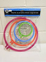 Front view of sealed 4-piece embroidery hoop set showing all hoops and packaging