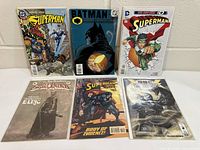Six comics laid out, showing variety of Superman, Batman, Elric and grayscale issue