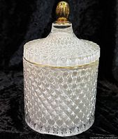 Full view of jar with lid on, showing diamond pattern and gold-tone finial