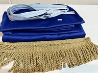 stacked royal blue fabric, gold bullion fringe trim, pale blue zippers