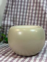 Front view of spherical matte khaki ceramic planter pot