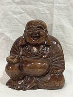 Front view of wooden Laughing Buddha with wealth pot and beaded necklace