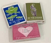 Front view of three inspirational card decks in plastic cases