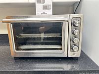 Front view of KitchenAid countertop convection oven showing controls and handle