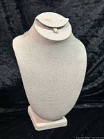 Front view of linen necklace display bust on pedestal base