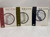 Front view of three Success Magazine audio CDs in sleeves
