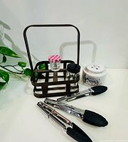 Overall shot of caddy, jars, honey pot and tongs