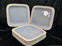 front view showing stack of plates and two displayed upright