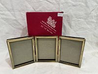 Front view of triple frame standing, box behind