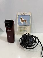 Trimmer, charger cord, instruction manual displayed